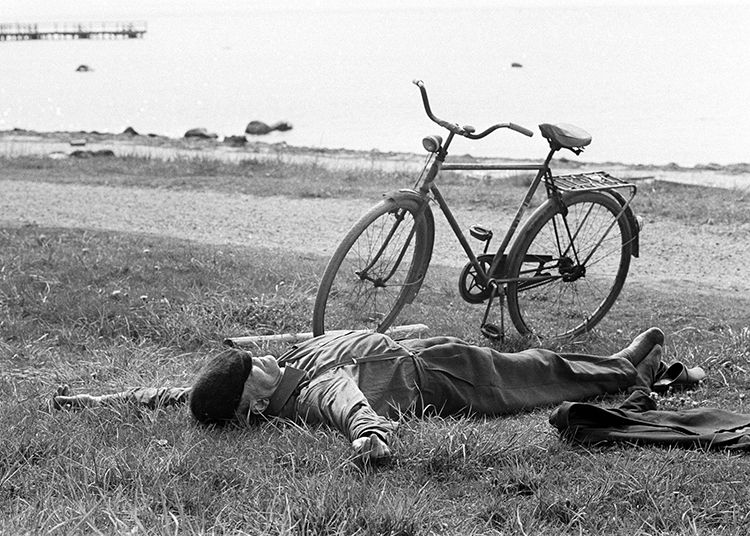 Man sleeping beside bike Man sleeping beside bike