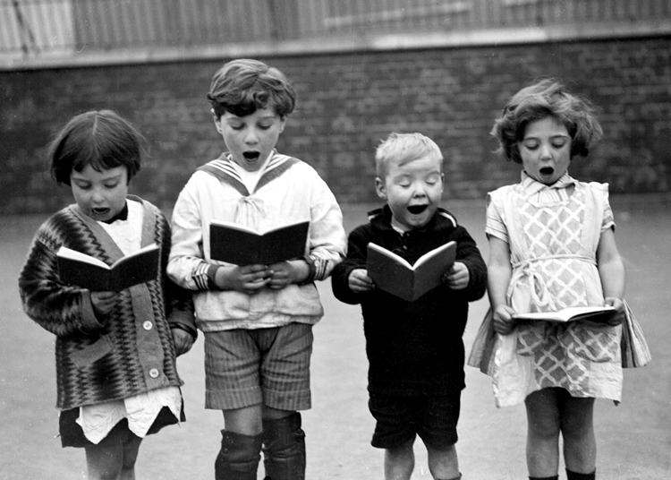 Children singing in schoolyard Children singing in schoolyard