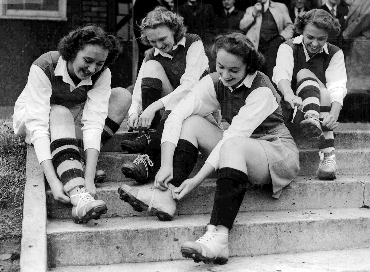 Female footballers booting up Female footballers booting up