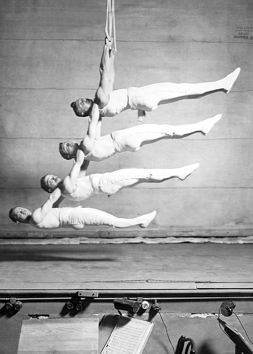 Four suspended gymnasts Four suspended gymnasts