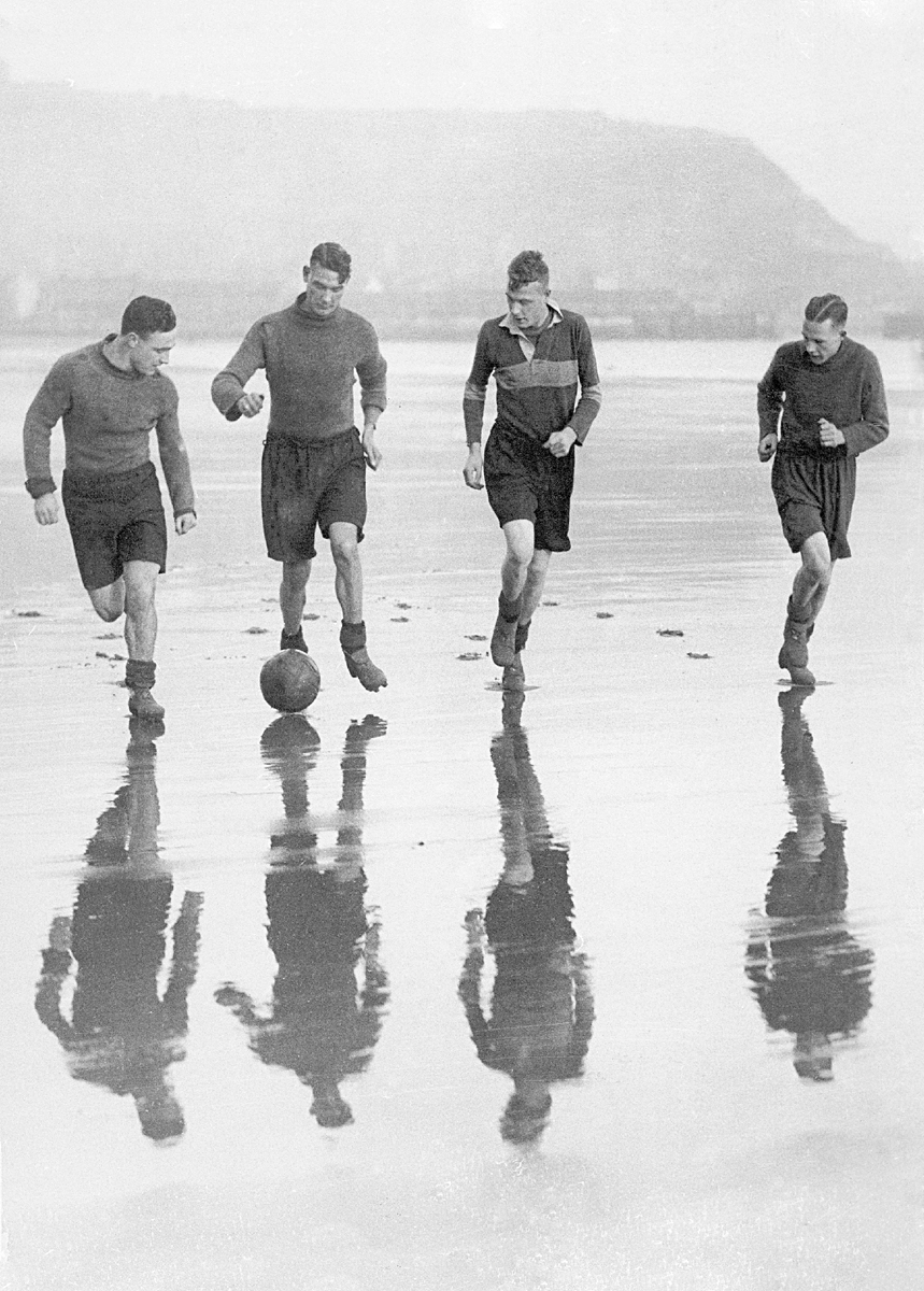 Footballers training on the beach Footballers training on the beach